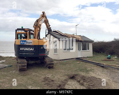 A home teetering on the edge of a cliff being demolished in Hemsby ...