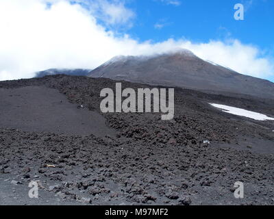 MOUNT ETNA, abandoned fuming crater in SICILY at ITALY, landscapes of tallest active volcano in EUROPE with cloudy blue sky in 2016 warm day on May. Stock Photo