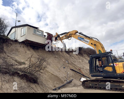 A home teetering on the edge of a cliff being demolished in Hemsby ...