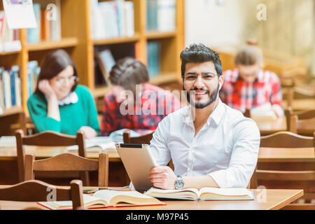 Student in the Library with Tablet PC Stock Photo