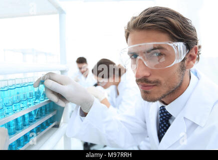 man in goggles to check fluid in vitro. Stock Photo