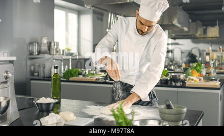 Baker Chef of Famous Restaurant Kneads the Dough in a Modern Looking Kitchen. Stock Photo