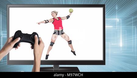 Hands holding gaming controller  with handball volleyball on television Stock Photo