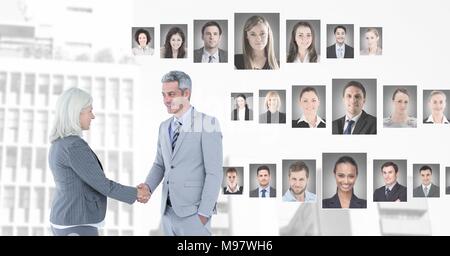 Business people shaking hands with portrait profiles of different people Stock Photo