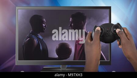 Hands holding gaming controller  with soccer player on television Stock Photo