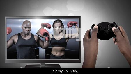 Hands holding gaming controller  with boxing fighters on television Stock Photo