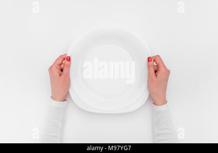 Female hands and an empty plate. Stock Photo