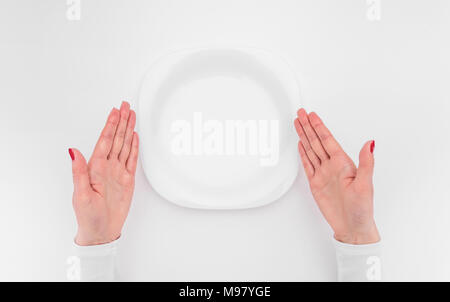 Female hands and an empty plate. Stock Photo
