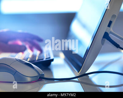 Detail of man working at computer Stock Photo