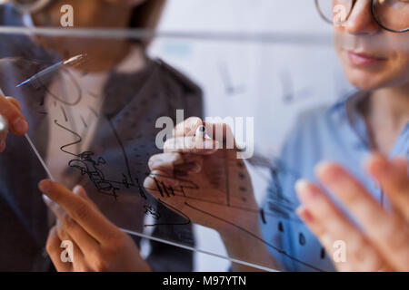 Female architects working on a project, holding outline Stock Photo