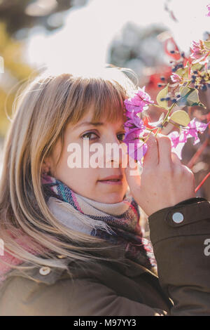 Portrait of a Woman smelling flowers Stock Photo - Alamy