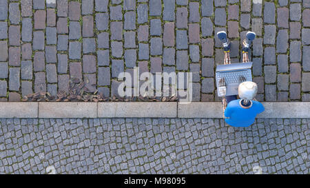 Robot sitting on curb using laptop, 3d rendering Stock Photo