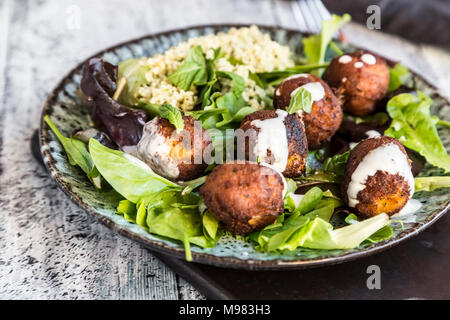 Plate of Falafel, salad, yogurt sauce with mint and Tabbouleh Stock Photo