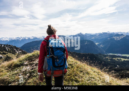 Austria, Tyrol, young woman hiking in the mountains Stock Photo