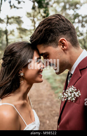 Happy wedding couple head to head looking at each other Stock Photo