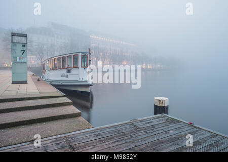 Germany, Hamburg, Jungfernstieg and passenger ship in fog Stock Photo