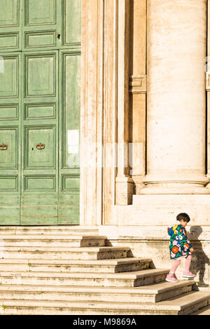 Chinese children on the steps of the Church of Santi Luca e Martina next to the Roman Forum, Rome, Lazio, Italy. Stock Photo