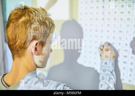 Student in class at interactive whiteboard Stock Photo