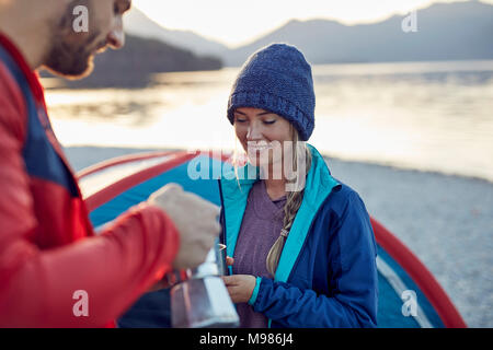 Young couple at tent having coffee break Stock Photo