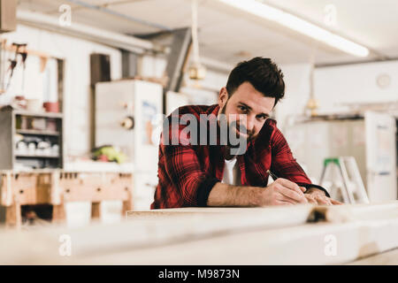 Portrait of smiling man in workshop Stock Photo
