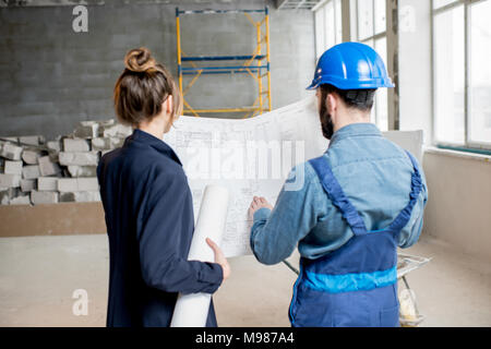 Builder with businesswoman at the construction site Stock Photo