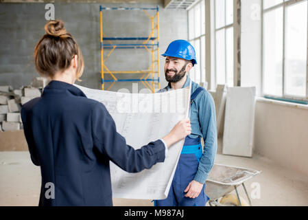Builder with businesswoman at the construction site Stock Photo