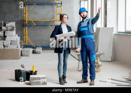 Builder with businesswoman at the construction site Stock Photo