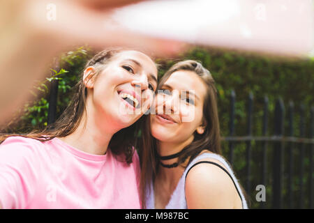 Two happy teenage girls taking a selfie Stock Photo