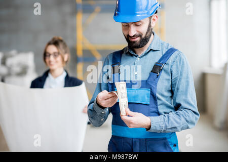 Builder counting money Stock Photo