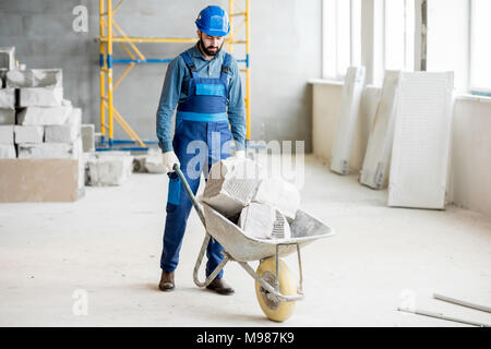 Carrying blocks on a wheelbarrow Stock Photo