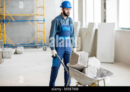 Carrying blocks on a wheelbarrow Stock Photo