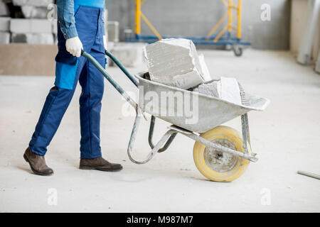 Carrying blocks on a wheelbarrow Stock Photo