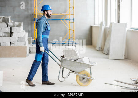Carrying blocks on a wheelbarrow Stock Photo