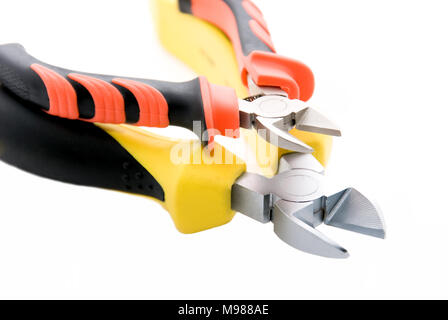 Small nippers lie on big Side Cutters isolated on a white background Stock Photo