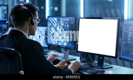 Professional IT Engineers Working in System Control Center Full of Monitors and Servers. Possibly Government Agency Conducts Investigation. Stock Photo