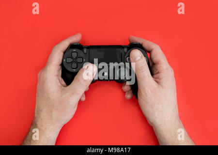 Male hands holding a PS4 controller Stock Photo - Alamy