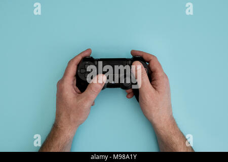 Male hands holding a PS4 controller Stock Photo - Alamy