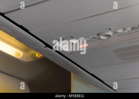 No Smoking Sign inside an airplane. Overhead console in the passenger aircraft Stock Photo