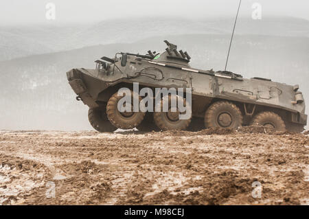 A Bulgarian BTR-60 Armored Personnel Carrier assigned to the 42nd Mechanized Infantry Battalion, Yambol, Bulgaria, traverses muddy terrain during partnership training with U.S. Soldiers assigned to Company B, 1st Battalion, 18th Infantry Regiment, 2nd Armored Brigade Combat Team, 1st Infantry Division, Fort Riley, Kansas, at the Novo Selo Training Area, Bulgaria, on March 23, 2018. The two allied forces participated in a two-day joint training exercise under the command and control of Bulgarian Lt. Col. Ivaylo Ivanov, battalion commander of the 42nd Mechanized Infantry Battalion. (U.S. Army ph Stock Photo