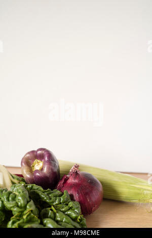 Purple and Green Vegetable Collection on Wood Counter Stock Photo
