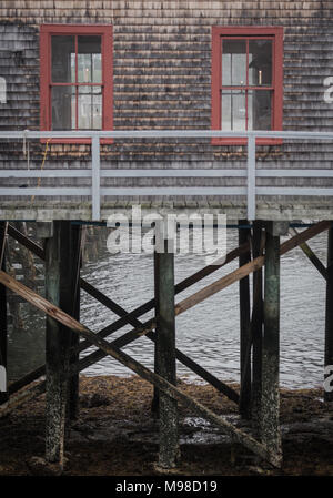 Shake Covered Shack on Stilts at low tide Stock Photo