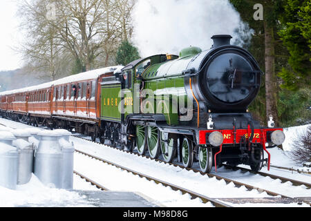 LNER steam locomotive 8572 pulling into Hampton Loade station in snow on the Severn Valley Railway, Shropshire, England, UK Stock Photo