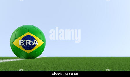 Soccer ball in brazils national colors on a soccer field. Copy space on the right side - 3D Rendering Stock Photo