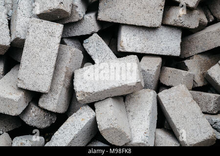 Stack of gray clay bricks for construction Stock Photo