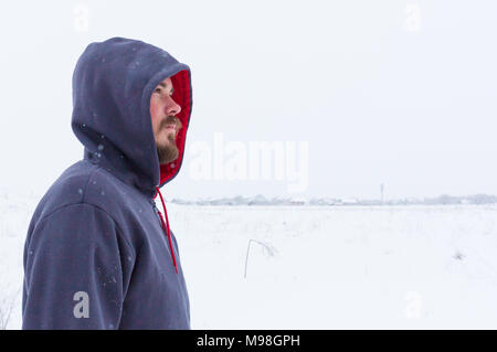 Man wearing blank grey hoodie, in the urban background near the river. Stock Photo