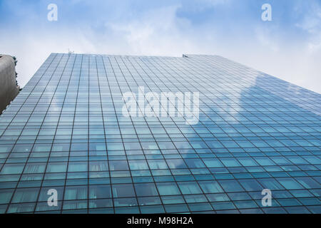 Perspective and underside angle view to textured background of modern glass building skyscrapers at night Stock Photo