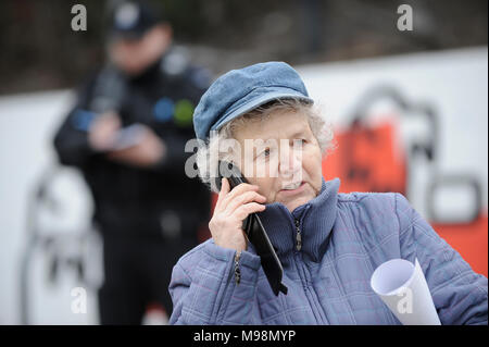 An elderly woman is seen using a smartphone in Warsaw, Poland on March 22, 2018. Stock Photo
