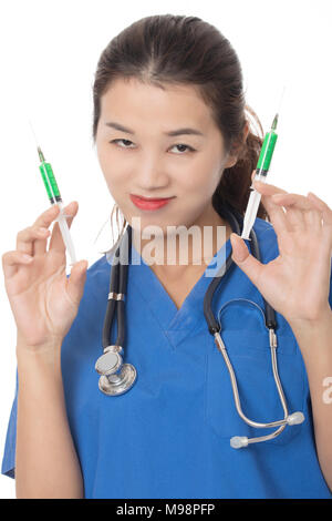 Evil Asian doctor or nurse holding a syringe filled with green medication isolated on a white background Stock Photo