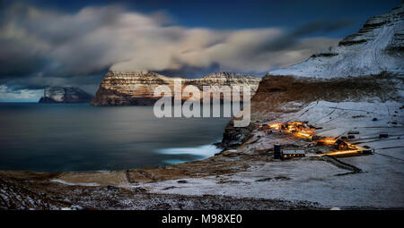 Trollanes village on Kalsoy island with Vidoy and Kunoy islands in the night, Faroe Islands Stock Photo