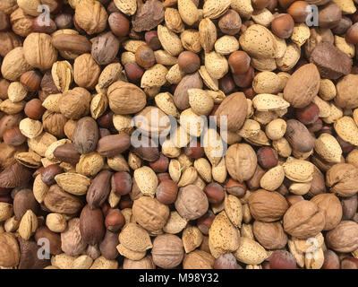 mixed nuts in their shells horizontal background Stock Photo